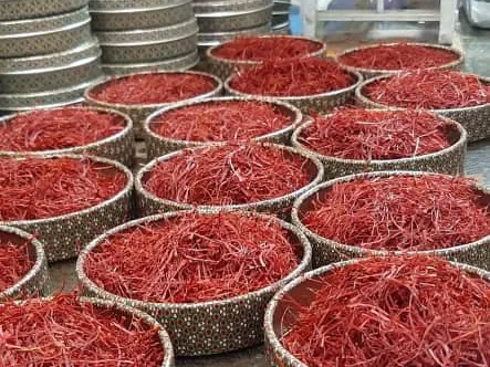 Rows of round tins filled with deep red saffron threads