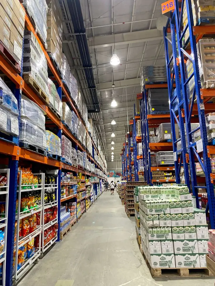 Warehouse aisle with tall pallet racking stocked with packaged food products